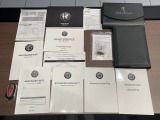 ディーラー車の書類は多岐にわたります。アルファロメオのシンボルマーク入り書類もきれいに保管されています。