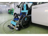 昇降スイッチを押し続けると、専用車いすが上昇を始めるとともに、固定装置でキッチリと固縛されます。