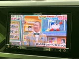 画面にはテレビ番組が表示され、停車中の休憩時間に映像を楽しめます。ボタンも画面下にまとまり、目的の操作を探しやすい配置です。日常のお出かけの合間にも便利にお使いいただけます。