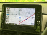 画面には地図と現在地が表示され、周辺の道路や施設を確認しやすい構成です。画面脇に操作ボタンやダイヤルが並び、案内の確認や各種操作に活用できます。