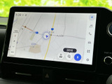 地図上に現在地や周辺道路が表示され、行き先までの道順を確認する際に便利です。画面上の検索や音声入力のアイコンも見やすく、目的地設定をスムーズに進められます。