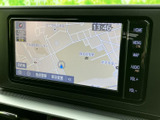 画面には周辺地図と現在地が表示され、目的地の設定や地図確認を行いやすい構成です。側面にホームや音量などのボタンが並び、必要な操作を選びやすくなっています。