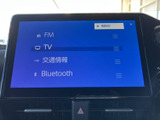 FMやテレビ、交通情報、Bluetoothなどの項目が画面に並び、使いたい機能を選びやすい構成です。日々の移動に合わせて、音楽や情報を確認できる便利な装備です。
